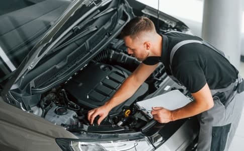 Hybrid Works technician inspecting a hybrid vehicle